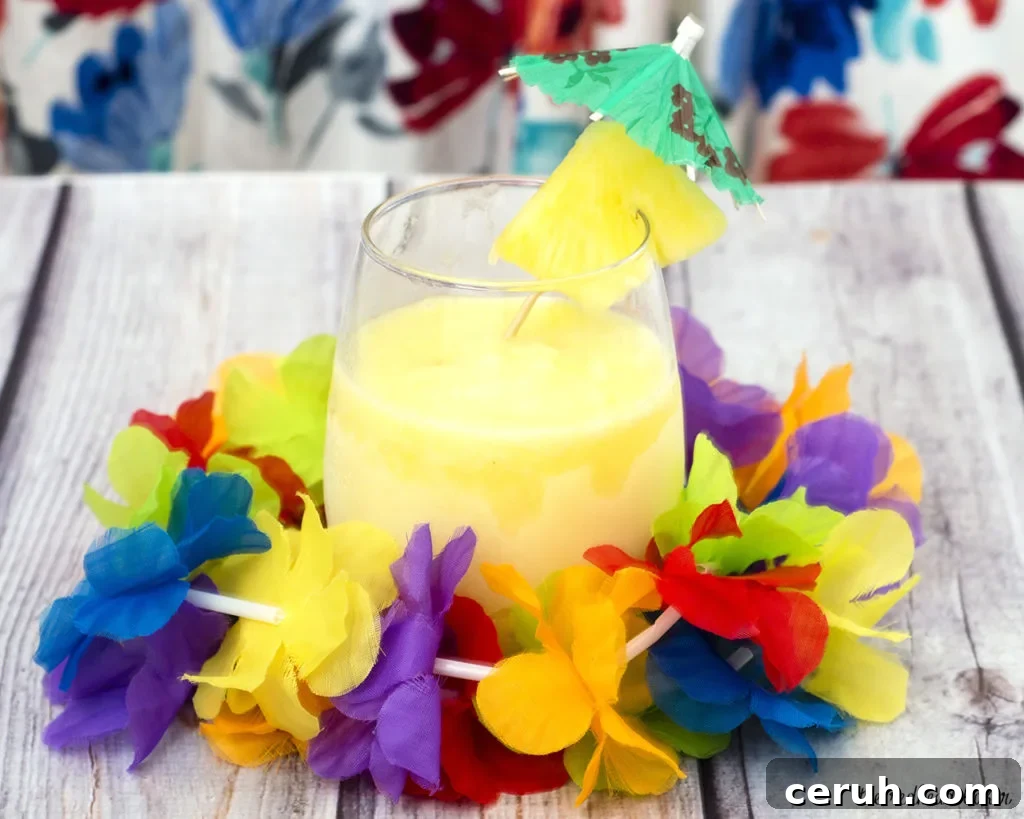 Frozen Piña Colada Recipe: Creamy Tropical Cocktail Guide 3 Have a taste of the tropics with a homemade frozen pina colada: a blend of ice, pineapple slices and juice, coconut cream and rum. #SundaySupper TheRedheadBaker.com