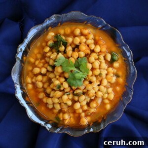 Imli chole served in a bowl on a dark blue background