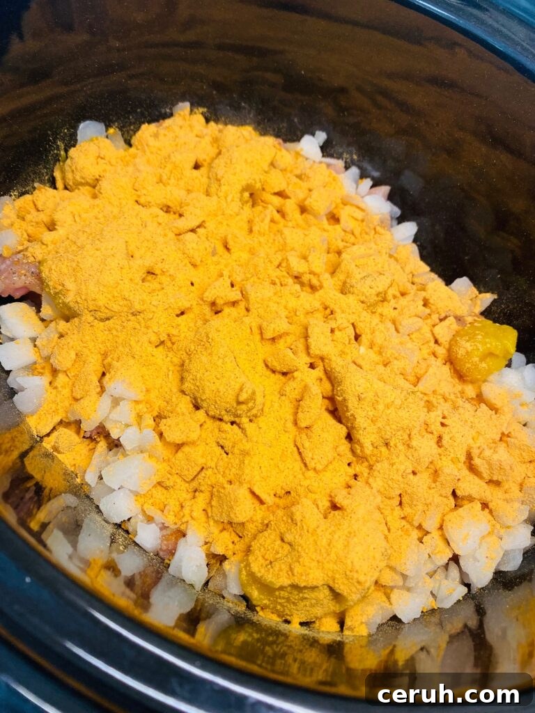Slow-Cooker Taco Chicken Recipe for Busy Weeknights 3 chicken in the slow cooker before stirring