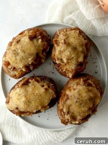 Loaded French onion baked potatoes on a plate.