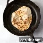 cooked Greek Yogurt flatbread in skillet.