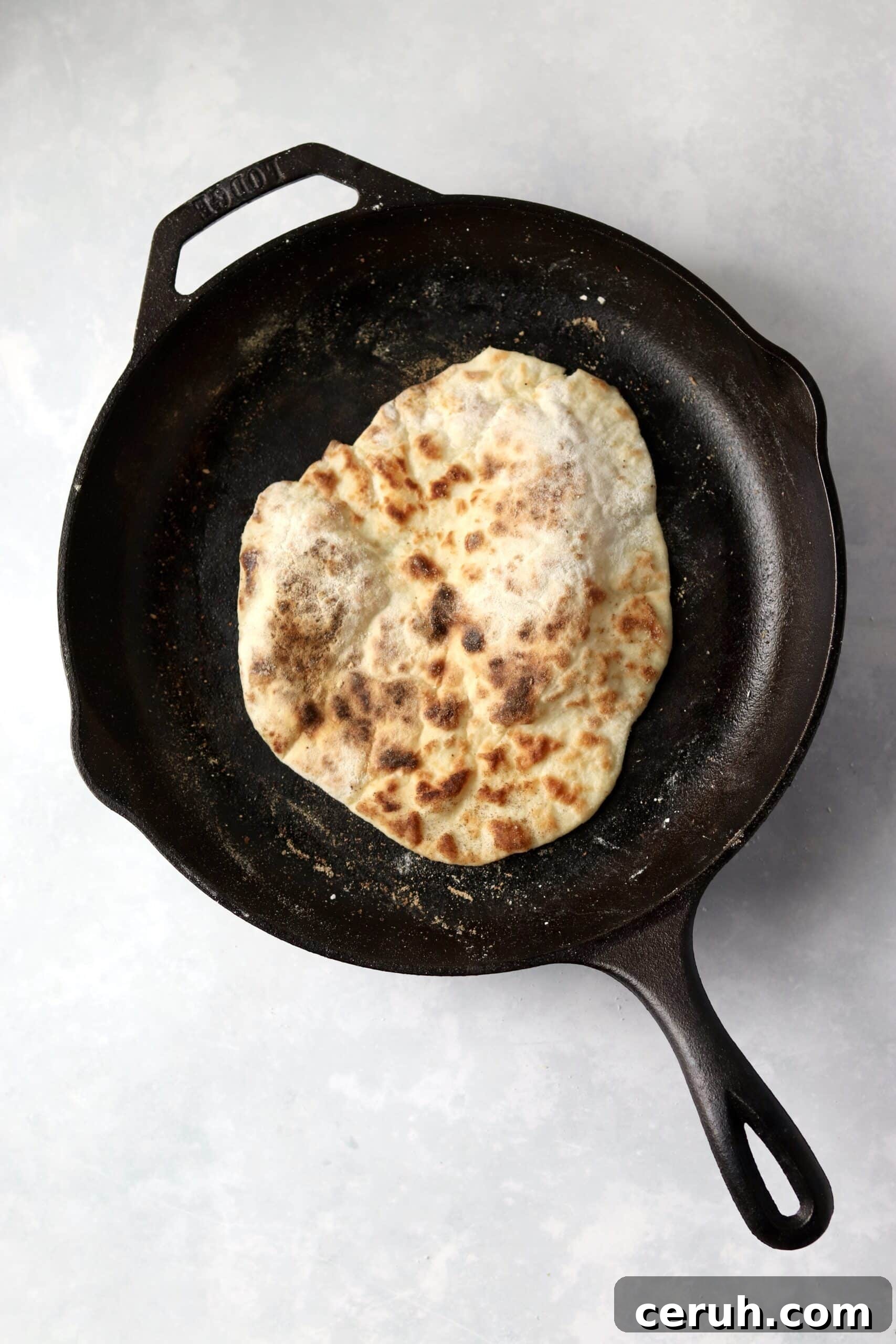 cooked Greek Yogurt flatbread in skillet.