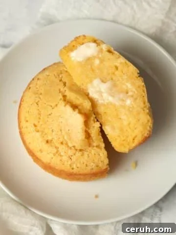 Single serve cornbread on a plate cut in half.