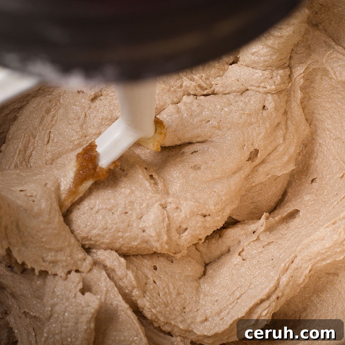 Using an electric mixer to beat butter, vegetable oil, brown sugar, and granulated sugar until the mixture is light and fluffy.
