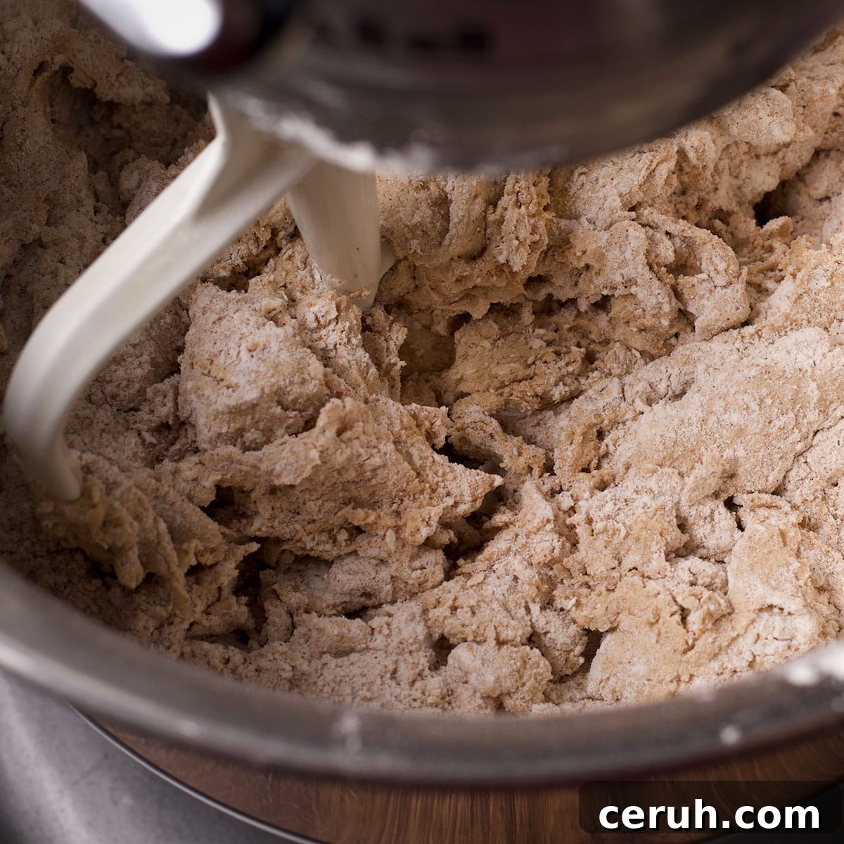 Using an electric mixer to beat the dry ingredients into the butter and sugar mixture.