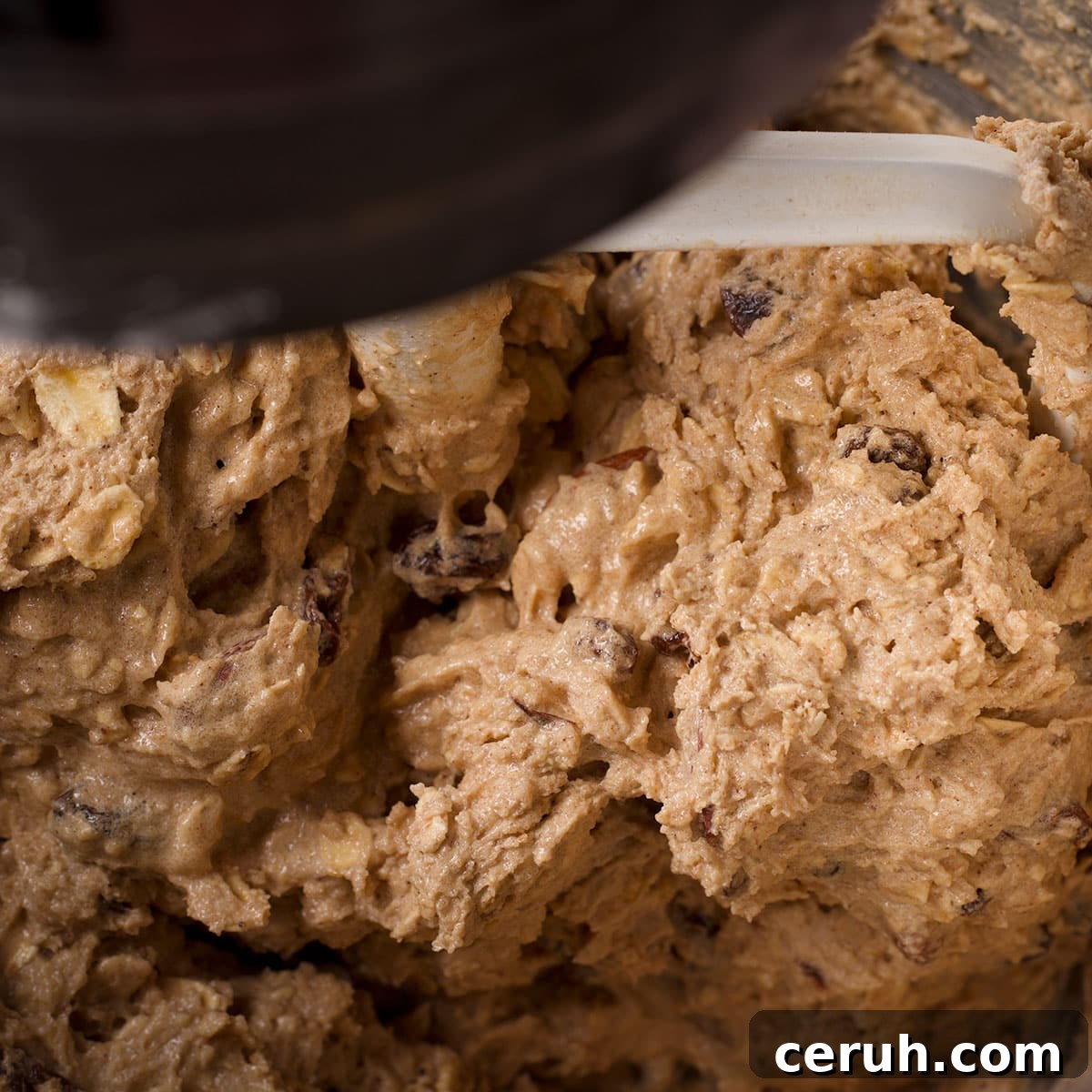 Mix the almonds, eggs, and raisins into the cookie dough.