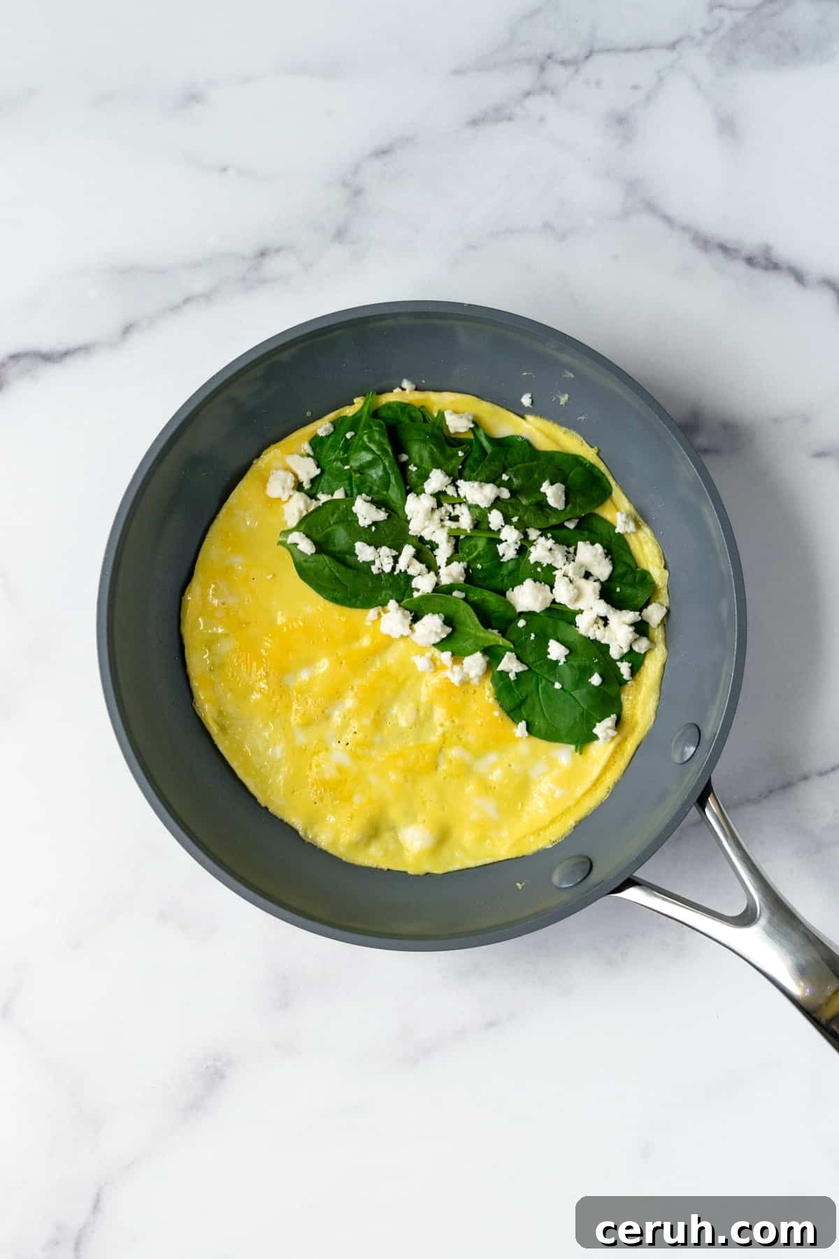 Omelet with Spinach and Feta in a Frying Pan.