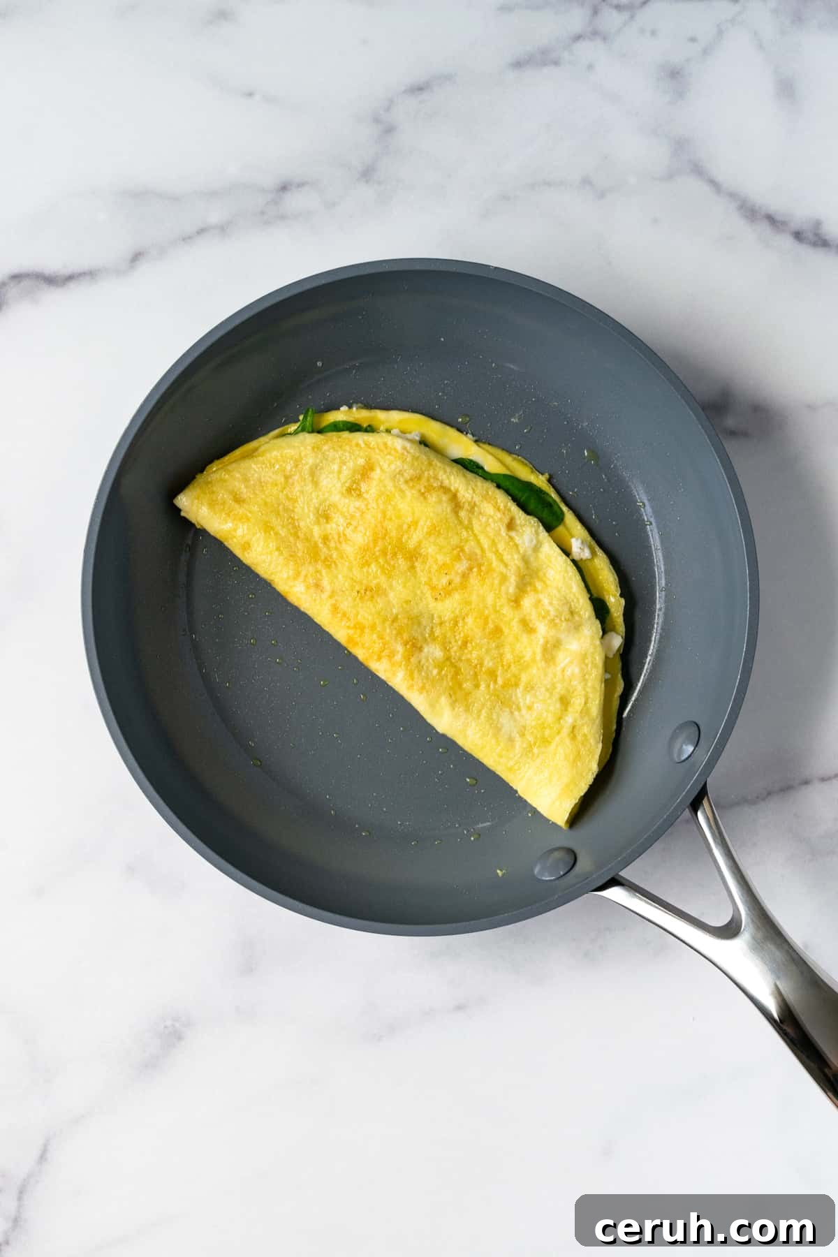 Spinach and Feta Omelet in a gray pan.