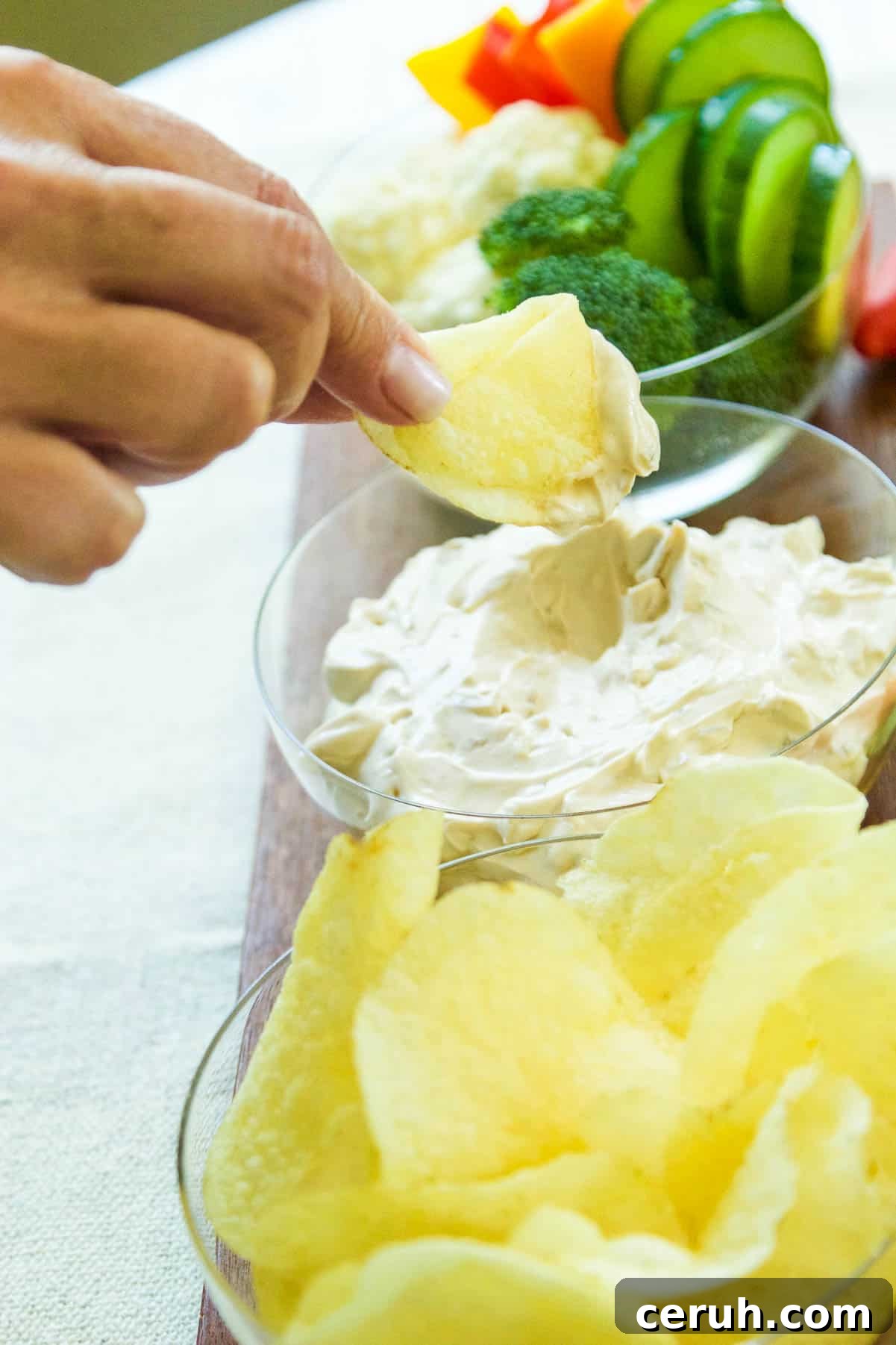 Onion dip being scooped with a chip