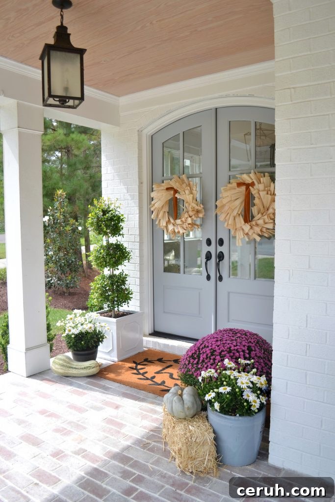 big front door, fall window boxes and wreaths