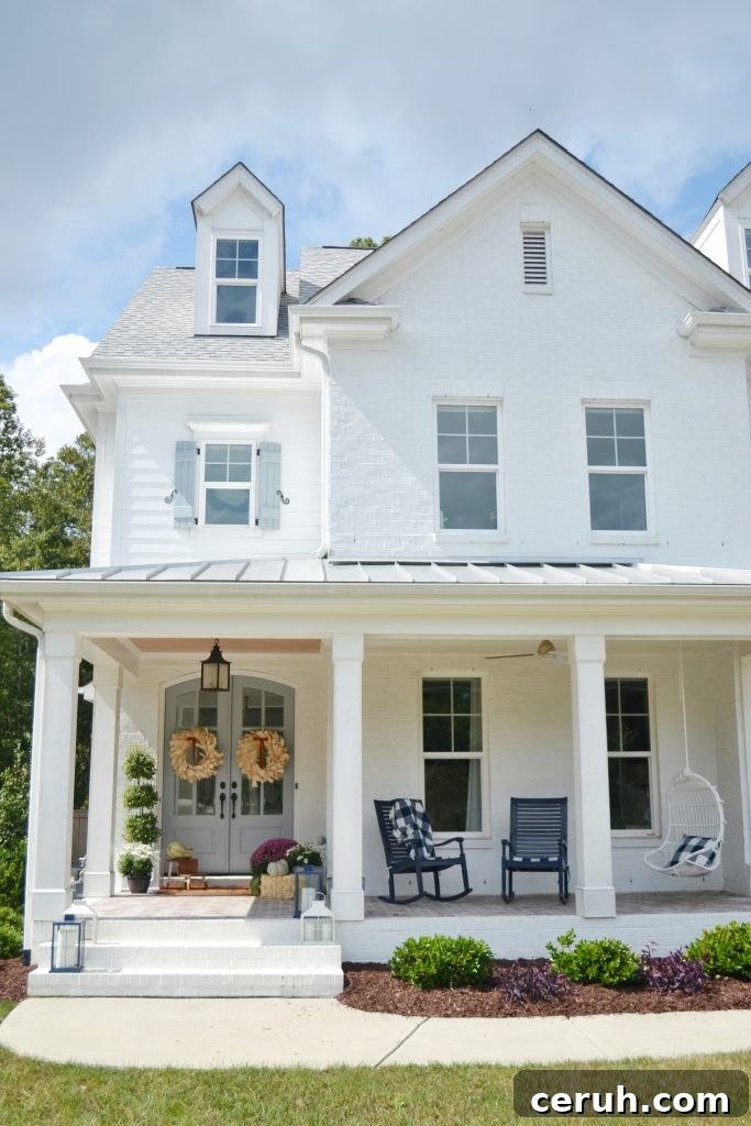 white home with corn husk wreaths on the door