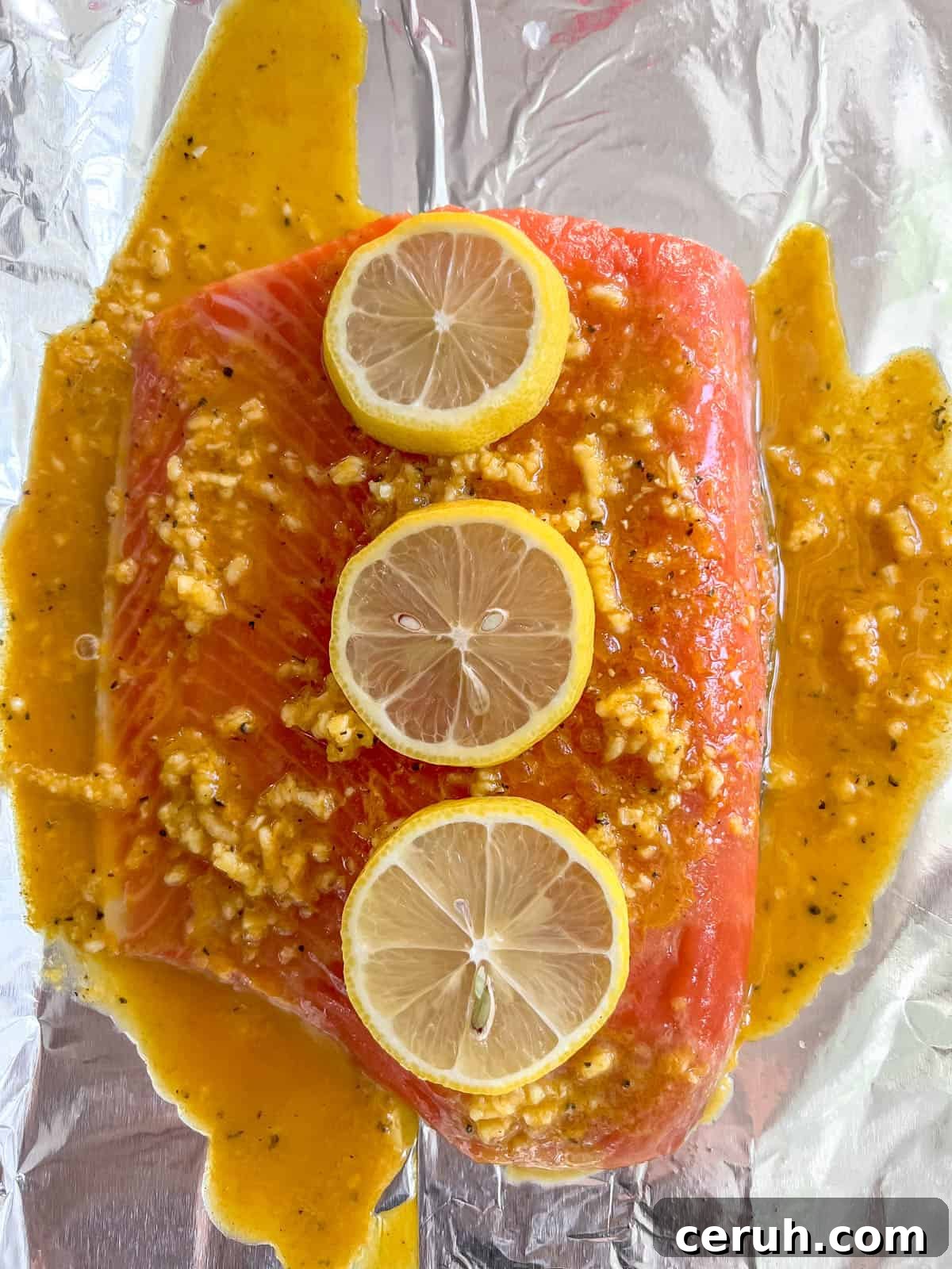 Lemon slices added to turmeric salmon sauce.