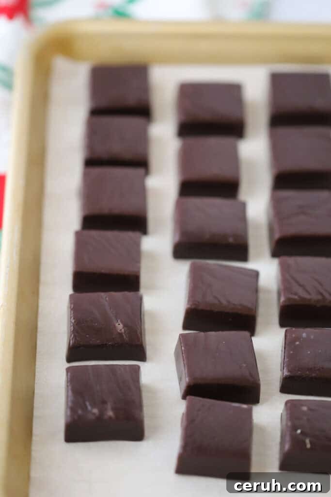 A tray full of cut black licorice caramels.