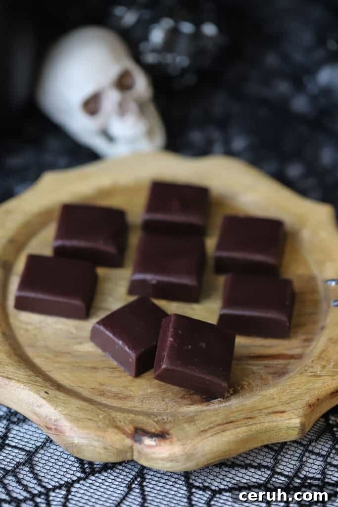 Homemade caramel candies on a wooden serving tray.
