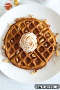 overhead shot of waffle on a white plate.