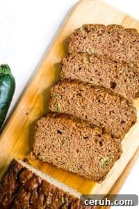 coconut flour zucchini bread sliced on a wooden board