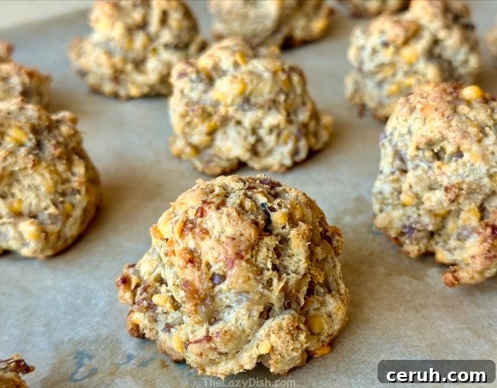 Golden brown sausage balls made with 4 ingredients: pancake mix, sausage, cheddar cheese and milk. A fun and easy breakfast idea!