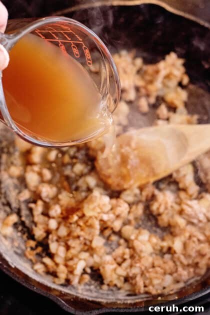 Add Zoup! Chicken Bone Broth to skillet.
