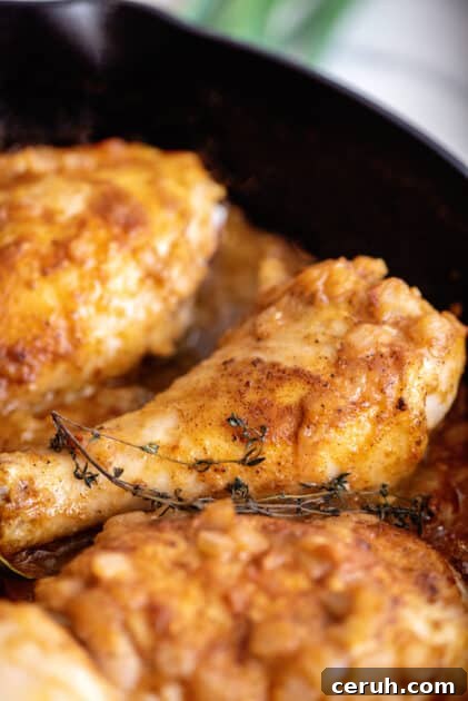 Southern smothered chicken in skillet.