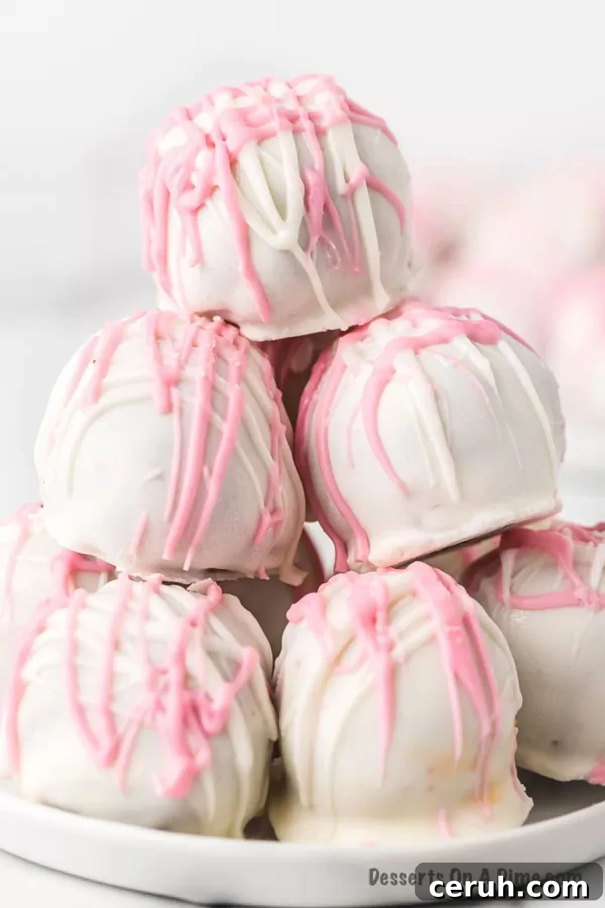 Red Velvet Cake Balls decorated and stacked on a platter