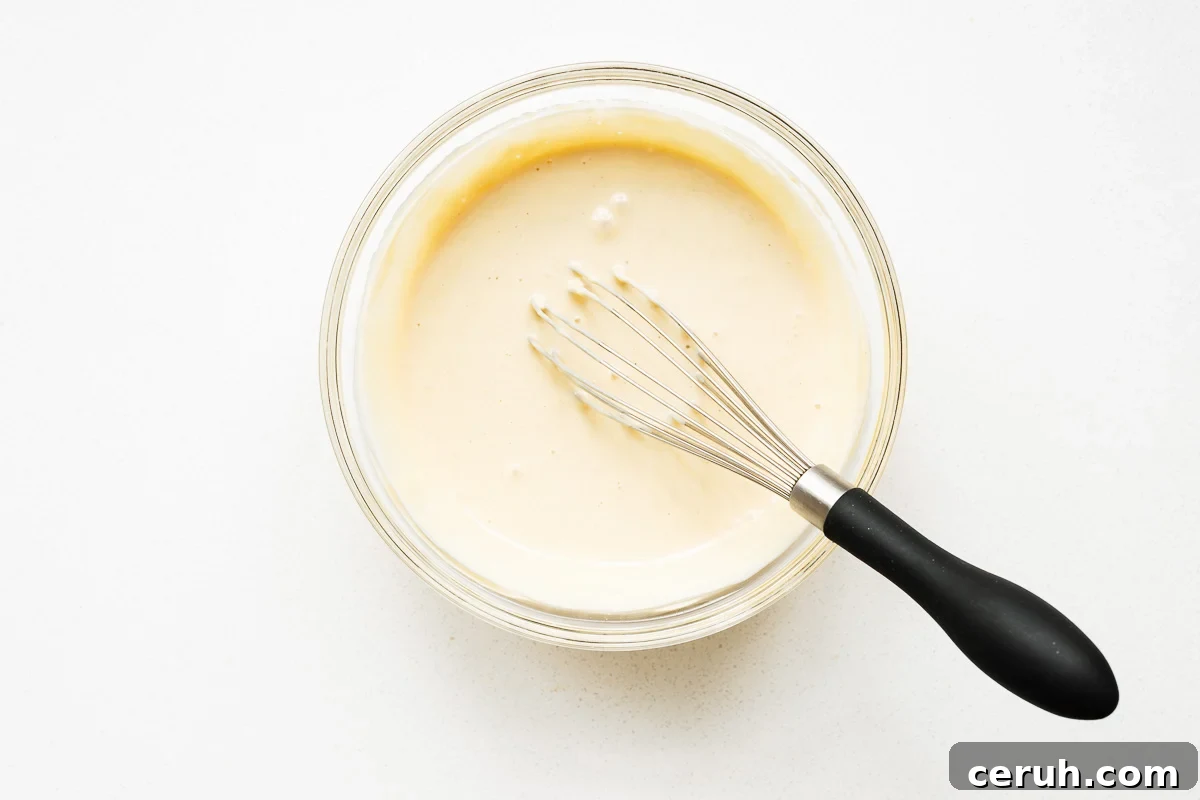 The plant-based maple tahini dressing is whisked until ultra-creamy, light and airy.