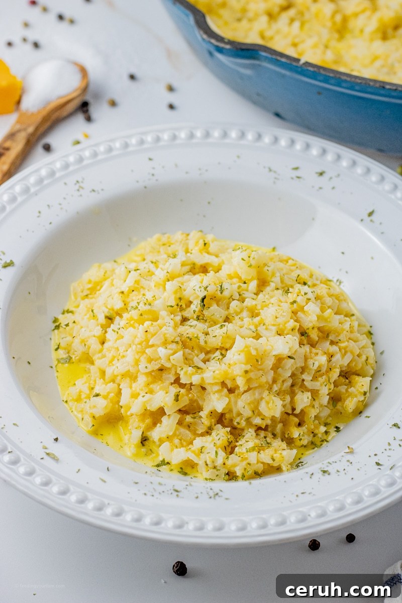cauliflower rice with cheesy sauce in a white bowl