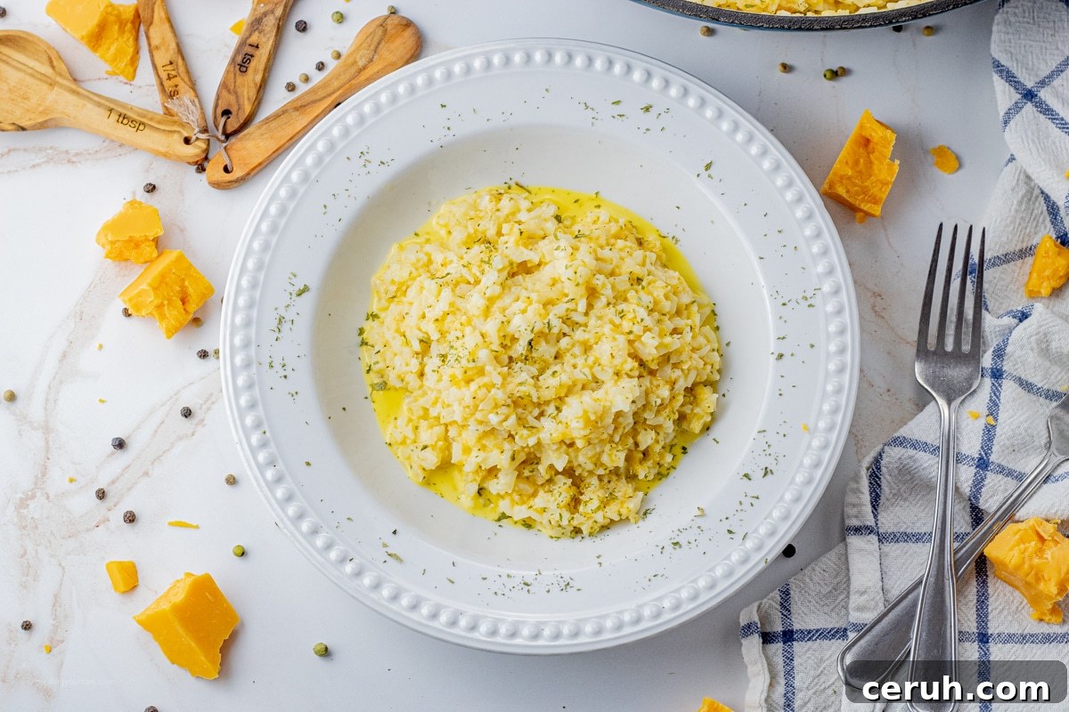white bowl of cheese and cauliflower rice