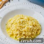cauliflower rice with cheesy sauce in a white bowl