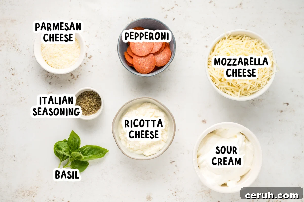 ingredients for slow cooker white pizza dip on a table.