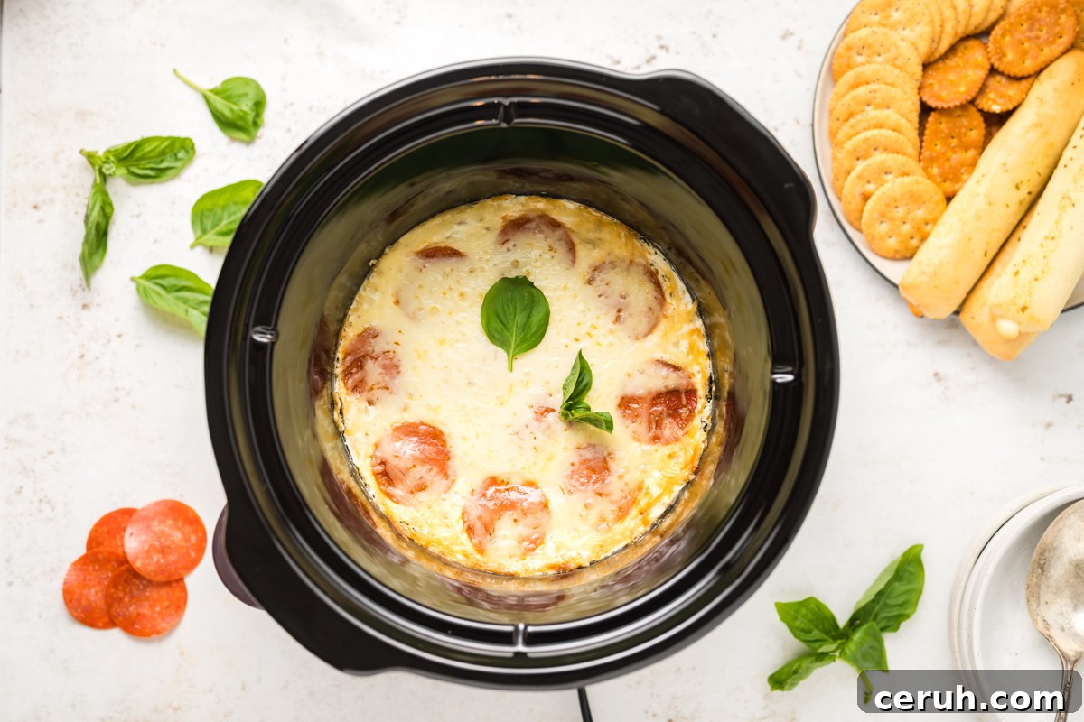 overhead of white pizza dip in a slow cooker.