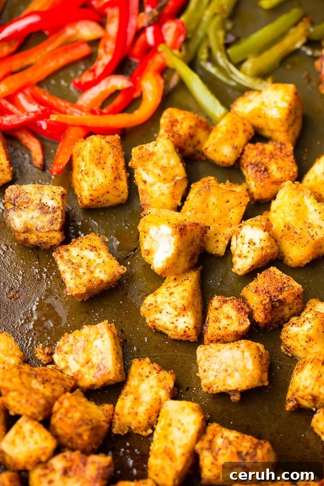 close up of tofu chikn on sheet pan with peppers