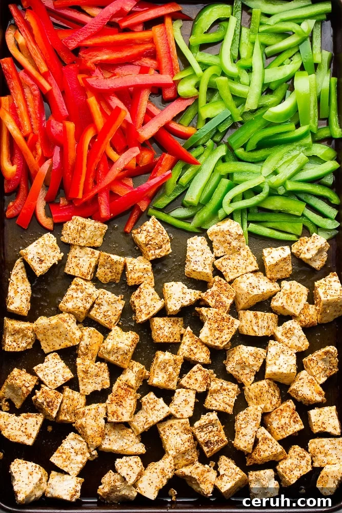 spiced tofu and peppers on sheet pan, not yet cooked