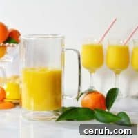 orange mango freeze in glasses and pitcher with tangerines