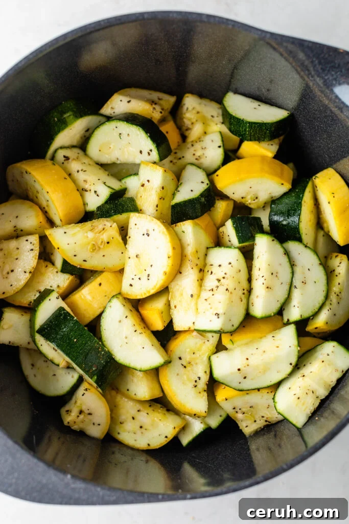 Roasted Zucchini and Summer Squash with Garlic and Parmesan 4 chopped zucchini and squash seasoned in a bowl
