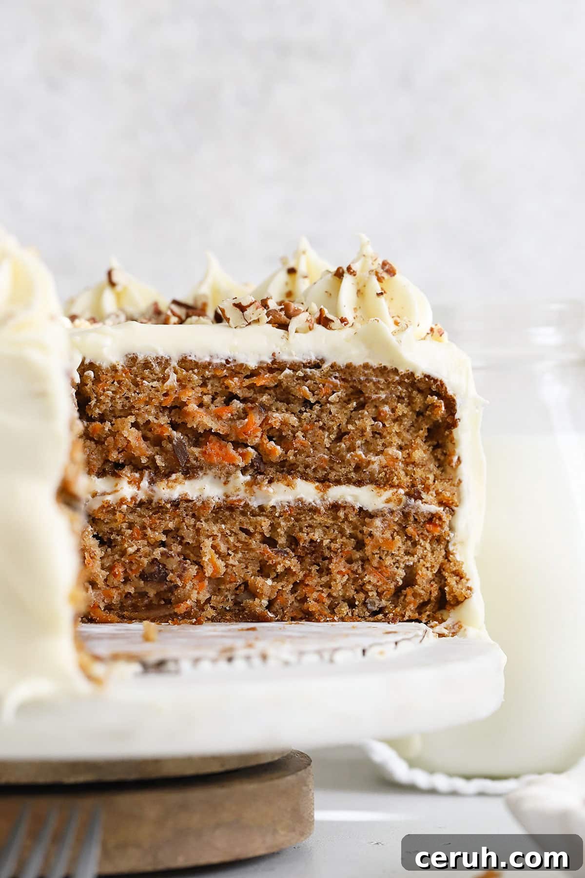 An inside view of a two-layer gluten-free carrot cake with cream cheese frosting