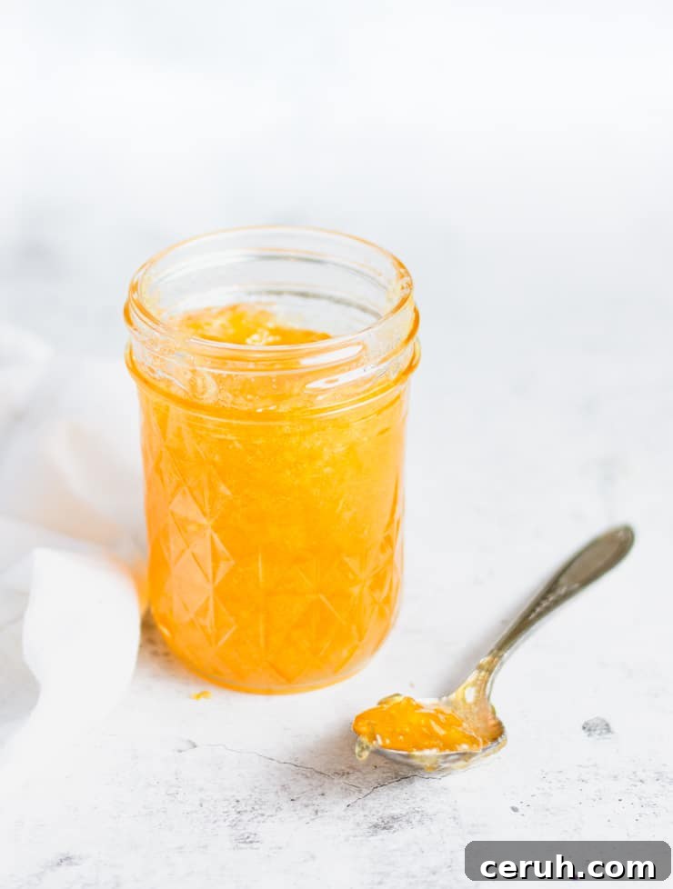 open jar of jam with a spoonful next to it