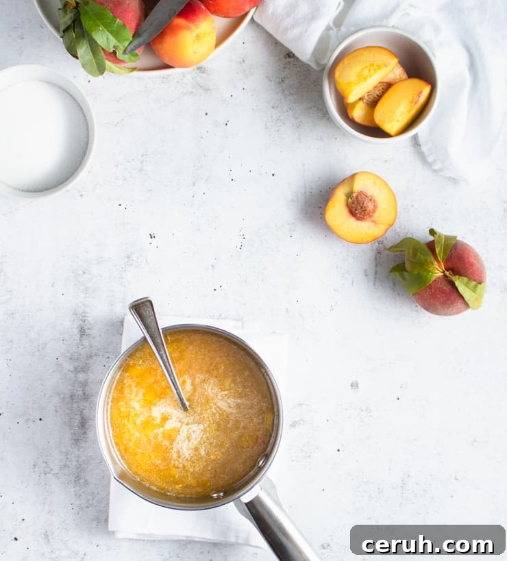 pan with peach jam cooking in it