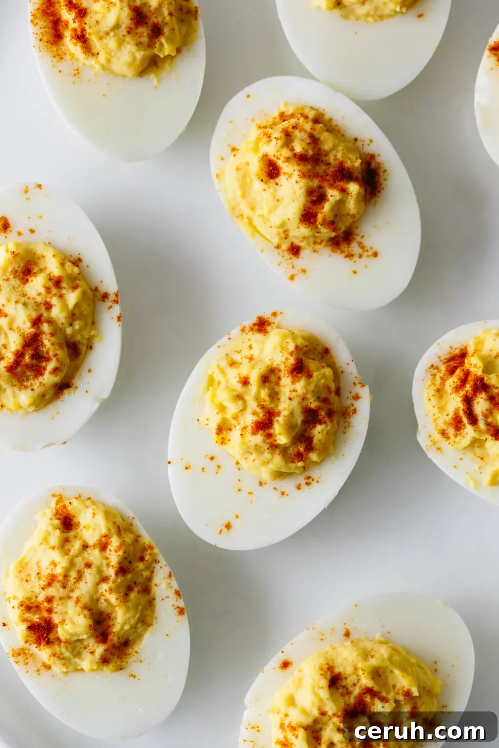 Deviled eggs are hard boiled eggs where the yolk is mixed with mayonnaise, mustard, vinegar, salt and pepper. A little sprinkle of paprika on top helps make these the best deviled eggs recipe.