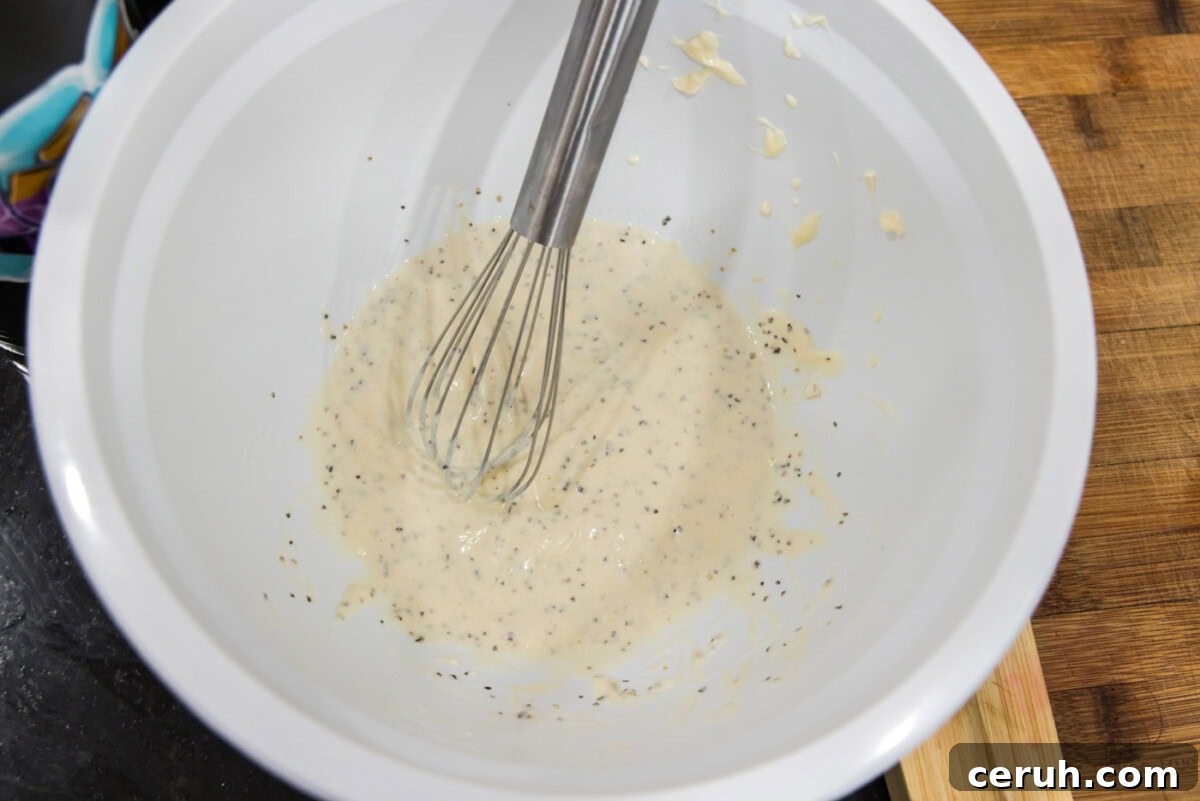 whisking mayo dressing in a bowl