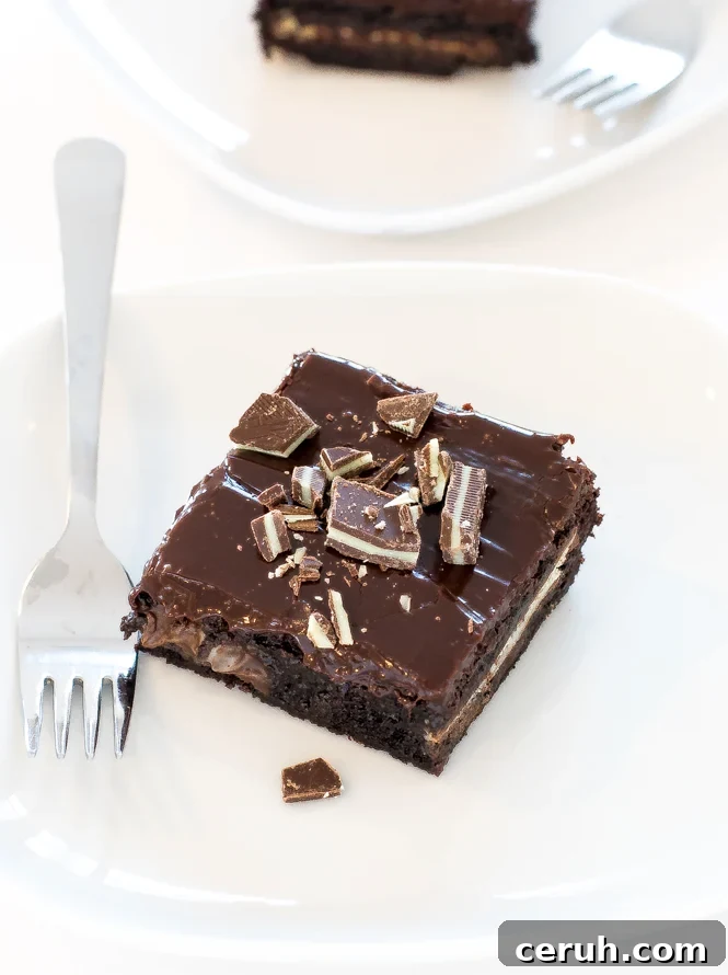 Fudgey chocolate mint Andes brownies on white plate with fork