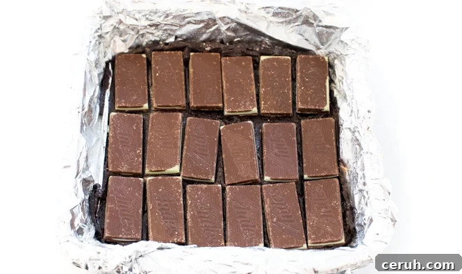 Topping brownie batter with andes mint candies