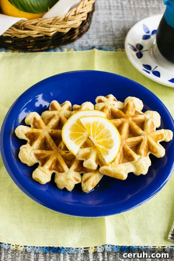 This recipe for lemon waffles made with sour cream are light and fluffy with the perfect amount of tang. Serve these waffles with maple syrup or lemon curd for the perfect weekend breakfast!