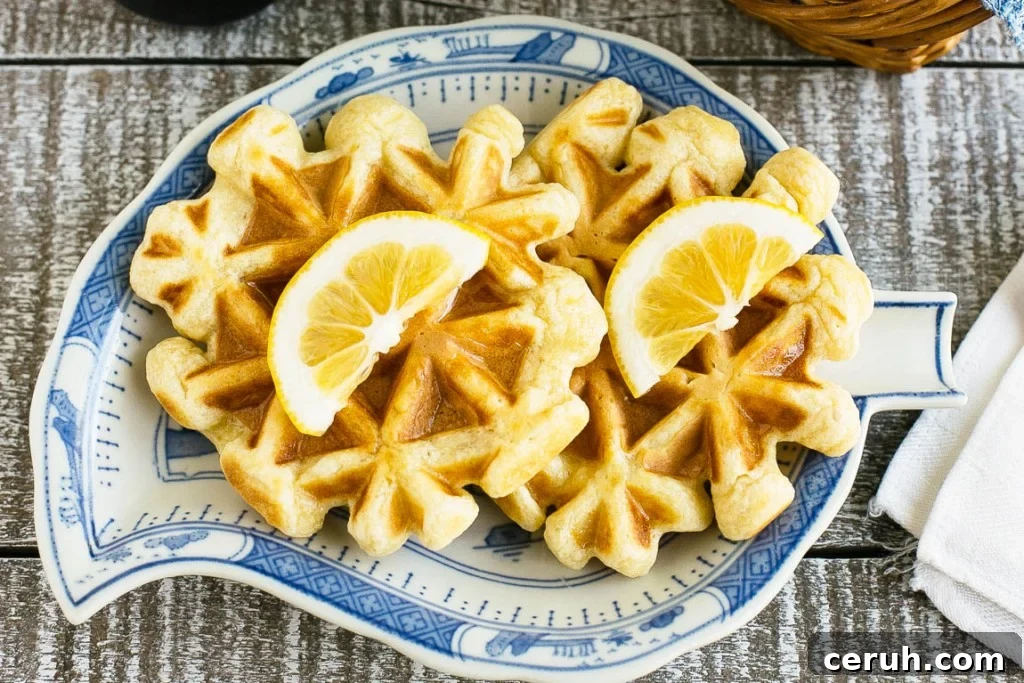 This recipe for lemon waffles made with sour cream are light and fluffy with the perfect amount of tang. Serve these waffles with maple syrup or lemon curd for the perfect weekend breakfast!