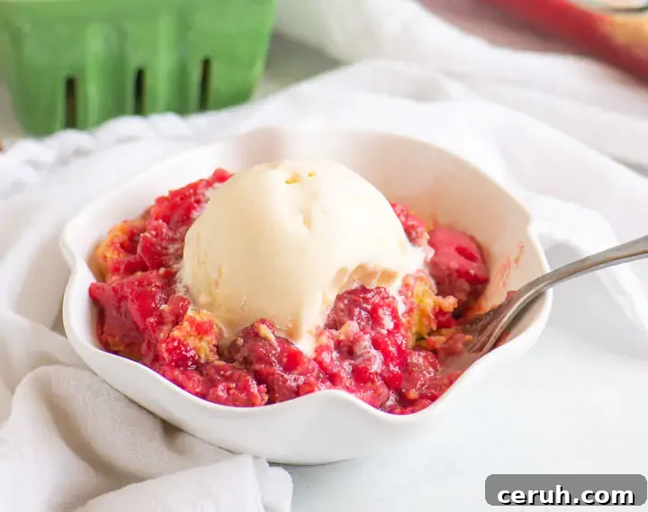 fork digging into a bowl of cobbler with vanilla ice cream