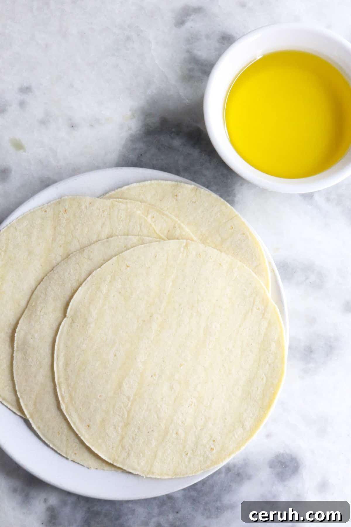 Homemade Tostada Shells: Crispy Tortilla Shell Recipe 3 Corn tortillas and a small bowl of oil