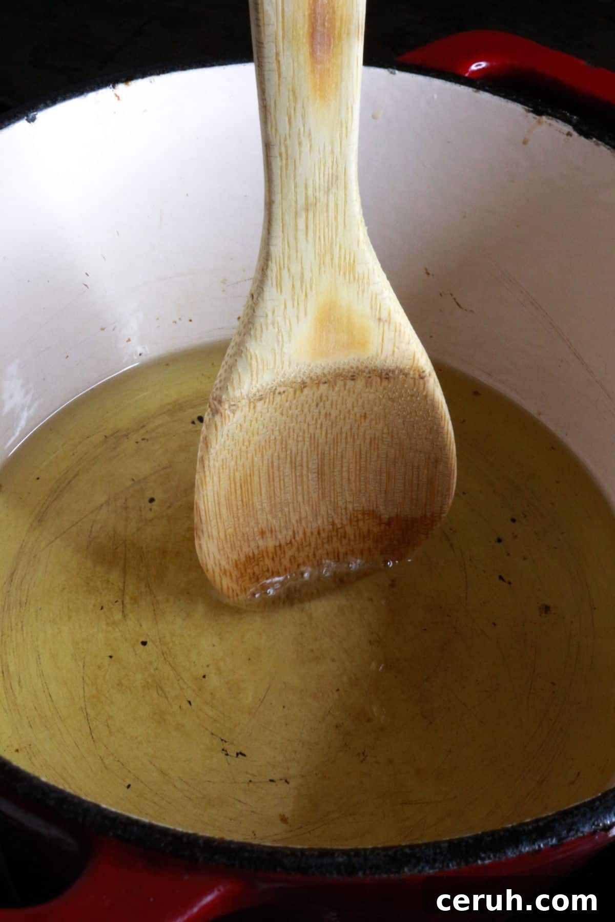 Homemade Tostada Shells: Crispy Tortilla Shell Recipe 4 Wooden spoon in oil
