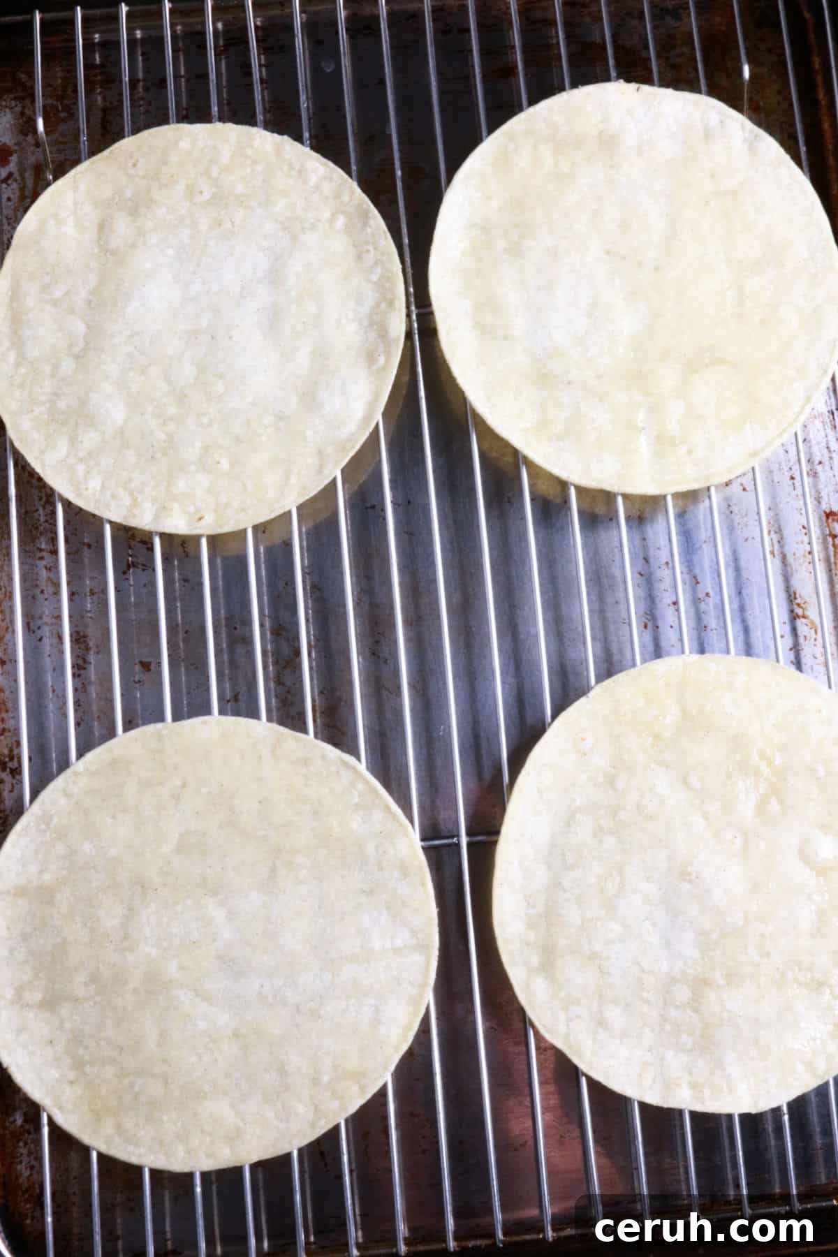 Homemade Tostada Shells: Crispy Tortilla Shell Recipe 8 Four corn tortillas on a wire rack