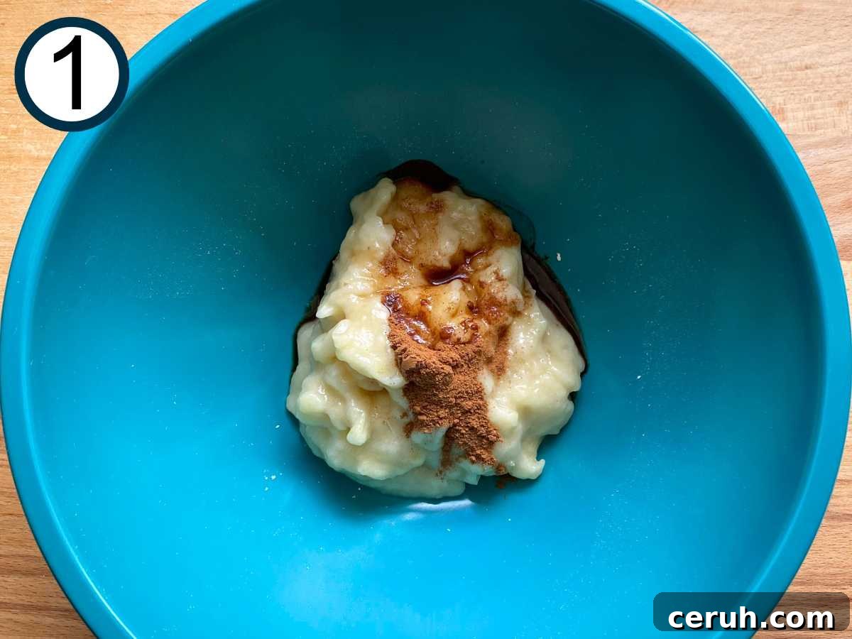 Mashed banana, vanilla extract and cinnamon in a medium bowl.