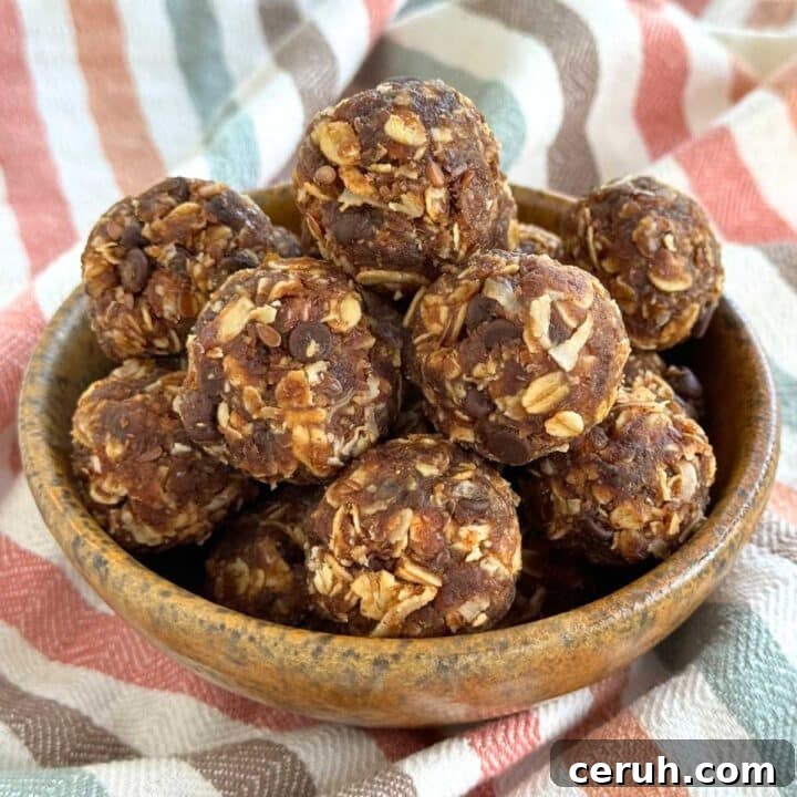 Healthy energy balls made with Medjool dates and oatmeal piled in a brown bowl on a colorful napkin.