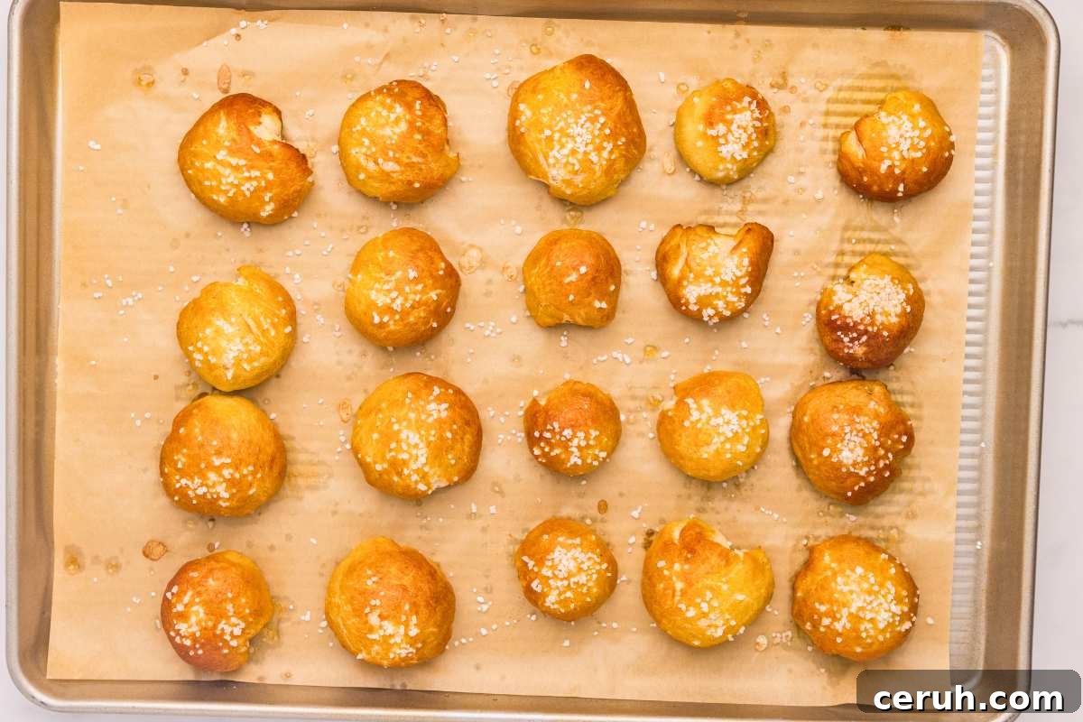 golden brown baked pretzel bites on baking tray.